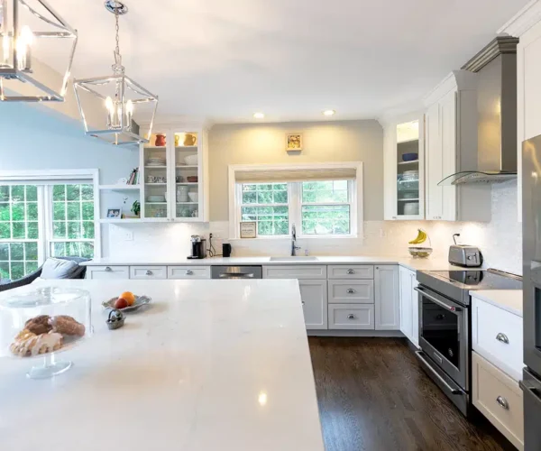 White shaker kitchen with chrome lantern pendants, remodel by VKB Kitchen & Bath