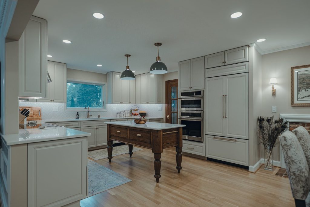 Wood island and panel-front refrigerator in a remodeled Bethesda kitchen