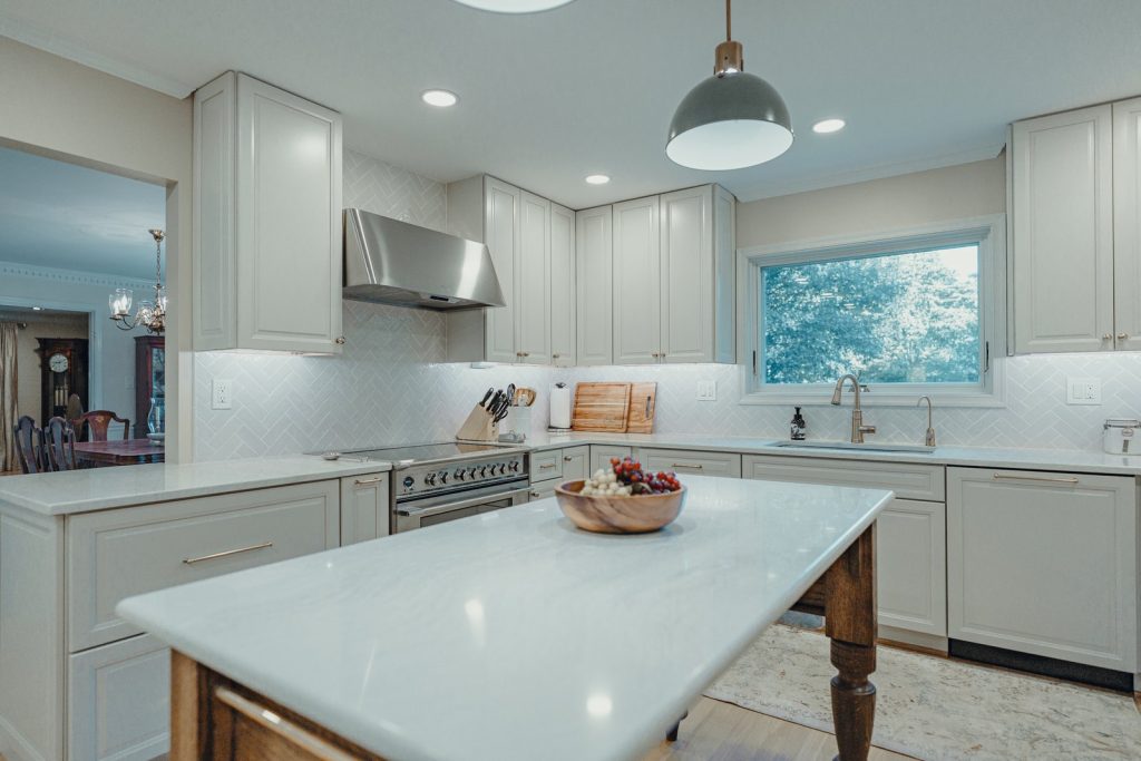 Range wall with a wall-mounted hood in a remodeled Bethesda kitchen