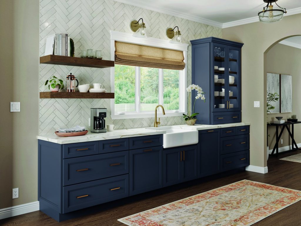 KraftMaid Vantage Taft navy sink wall with open shelves and a farmhouse sink
